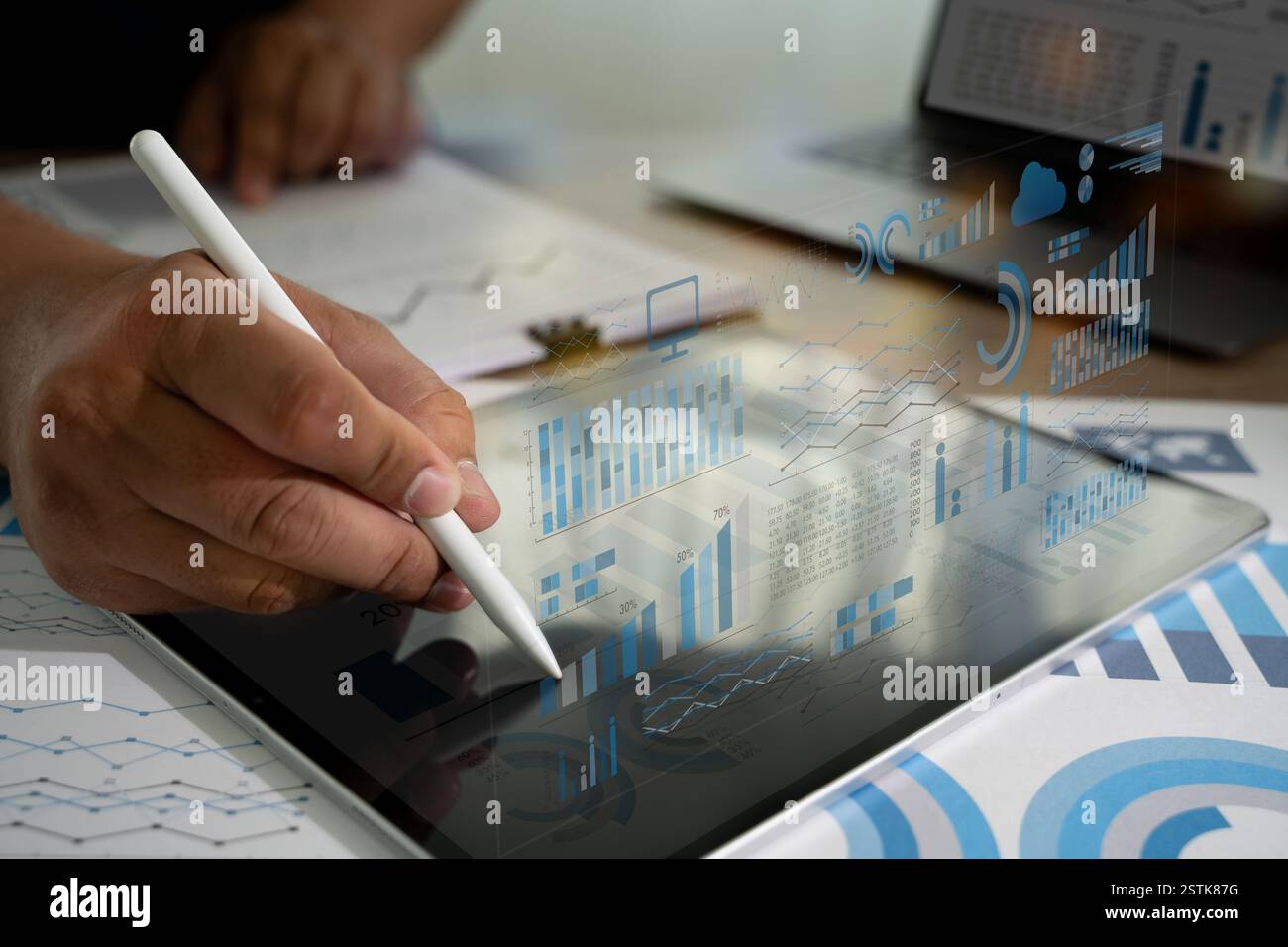 businessman write Statistics Data on a tablet, which is displaying a graph analyzing sales data and financial growth graph chart report Stock Photo