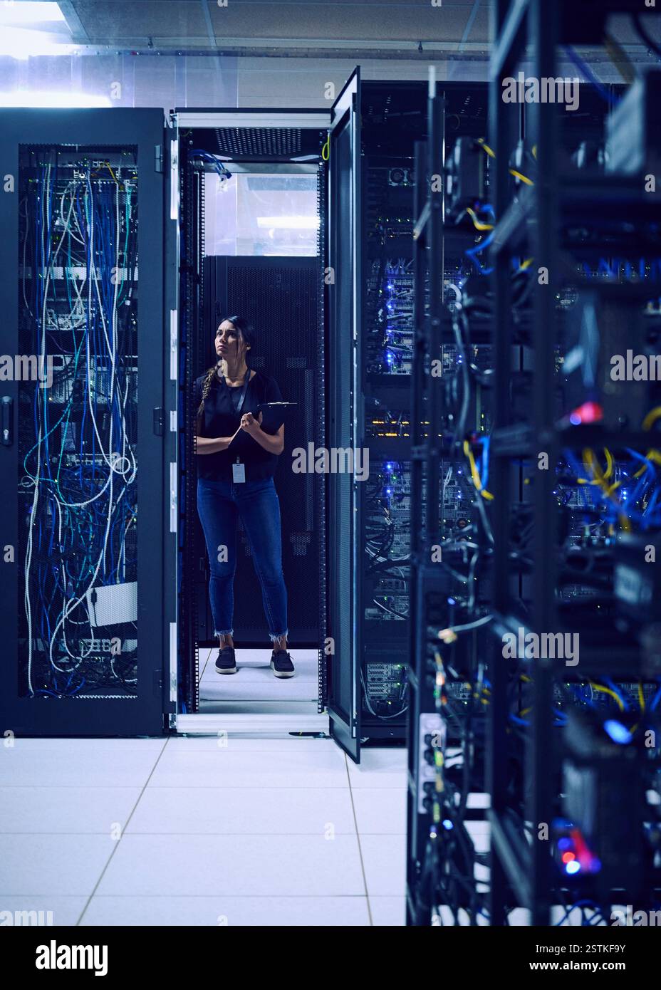 Female technician standing in server room Stock Photo