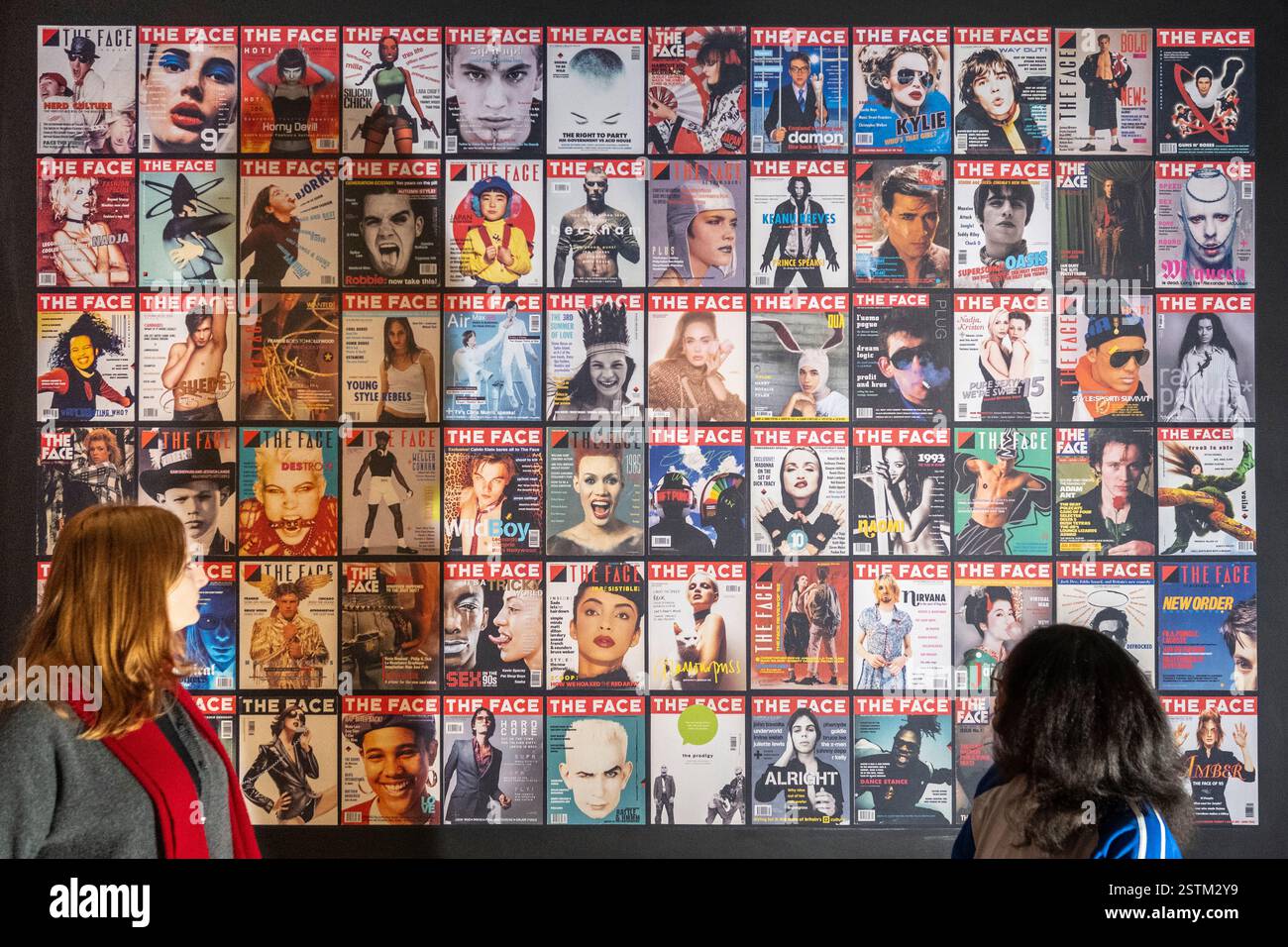 [Editorial Use Only – Critique or review only] London, UK.  19 February 2025. Staff members with a wall of front covers at a preview of ‘The Face Magazine: Culture Shift’ at the National Portrait Gallery.  The exhibition celebrates images from The Face, the youth culture and style magazine which ran from 1980 to 2004, that has shaped the creative and cultural landscape in Britain and beyond.  The show runs 20 February to 18 May 2025. Credit: Stephen Chung / Alamy Live News Stock Photo