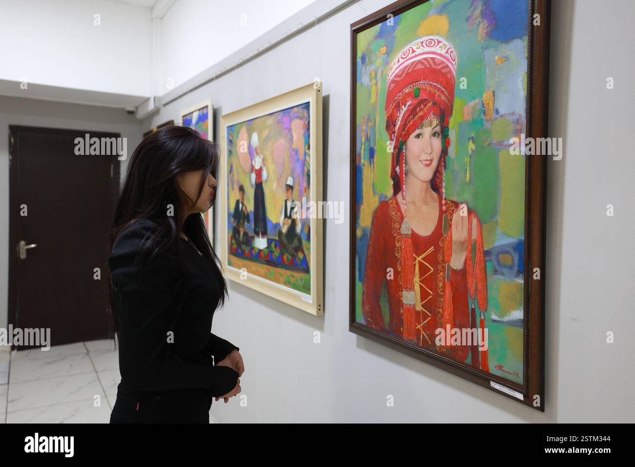 Bishkek, Kyrgyzstan. 18th Feb, 2025. A woman visits an exhibition of