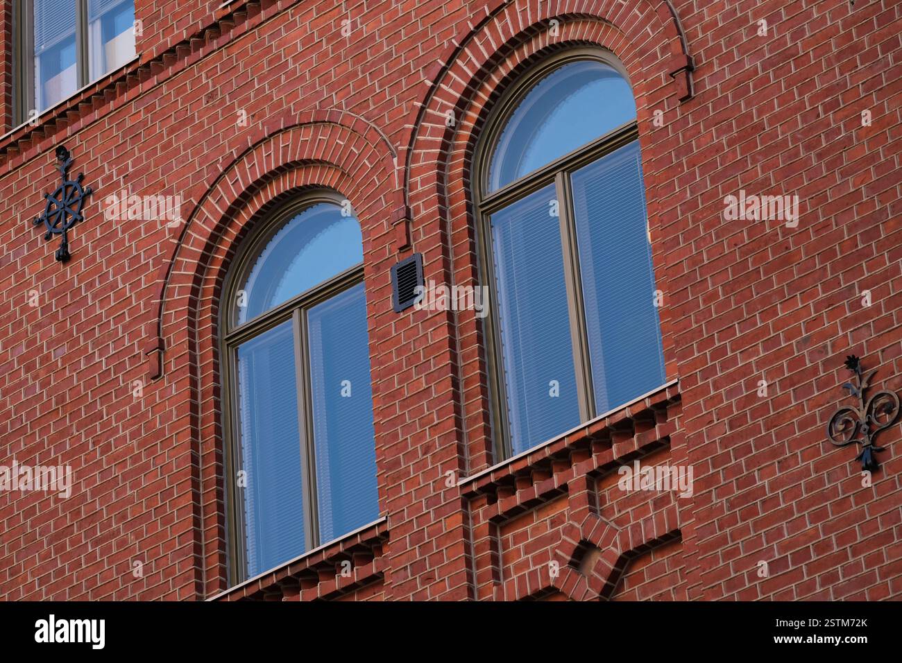Two windows on a brick red wall Stock Photo