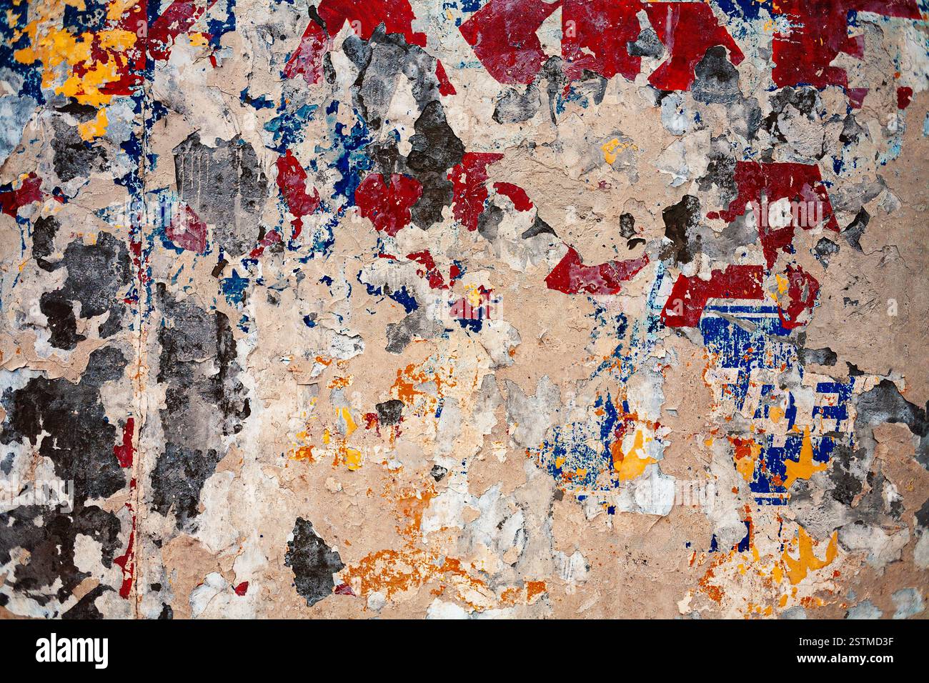 Bumpy plastered wall covered with mess of color spots Stock Photo