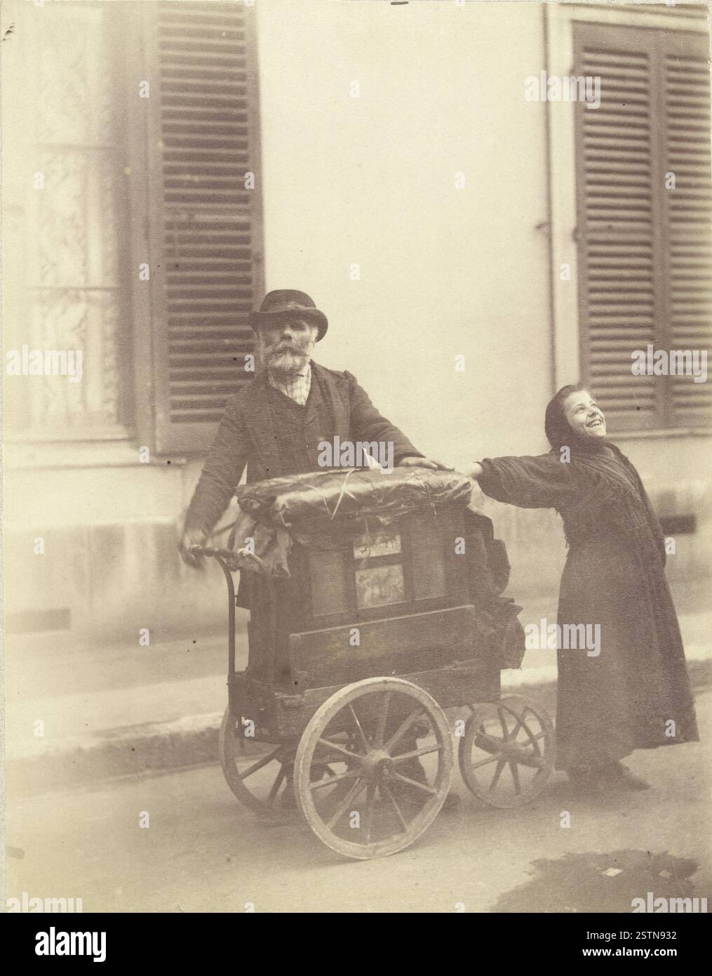 A 1898 photograph by Eugène Atget depicting a musician with an ...