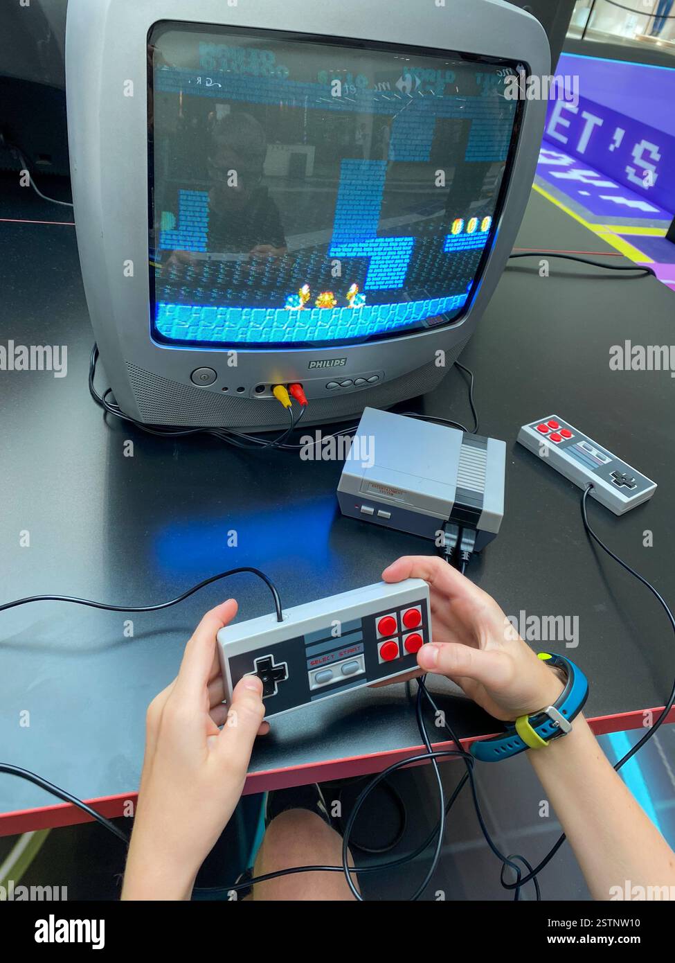 Child playing Mario  on a retro videogame console - Smartphone Captured Stock Image