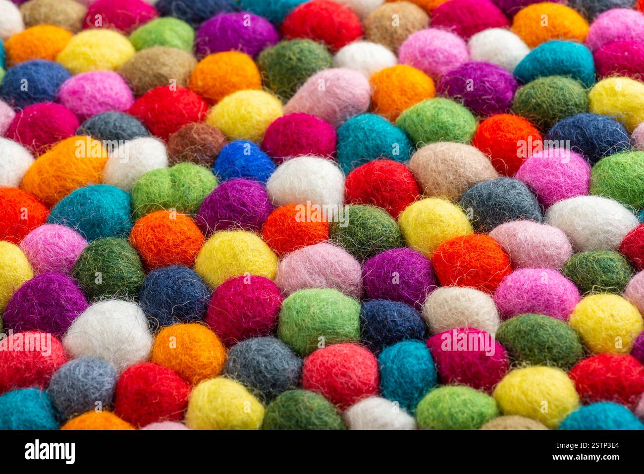 Multicolored felt ball rug detail Stock Photo