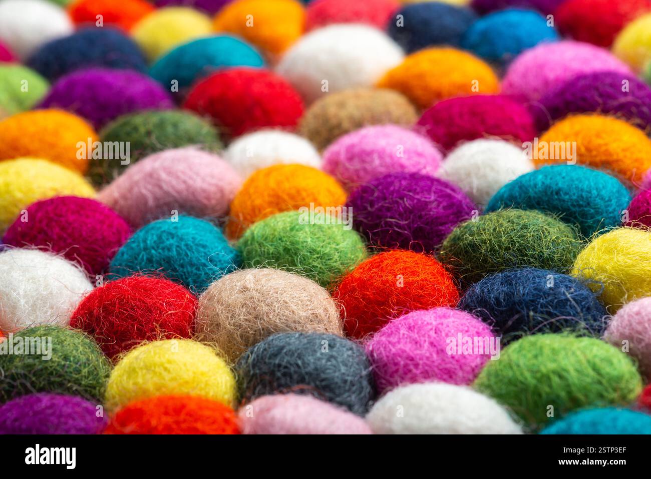 Multicolored felt ball rug detail Stock Photo