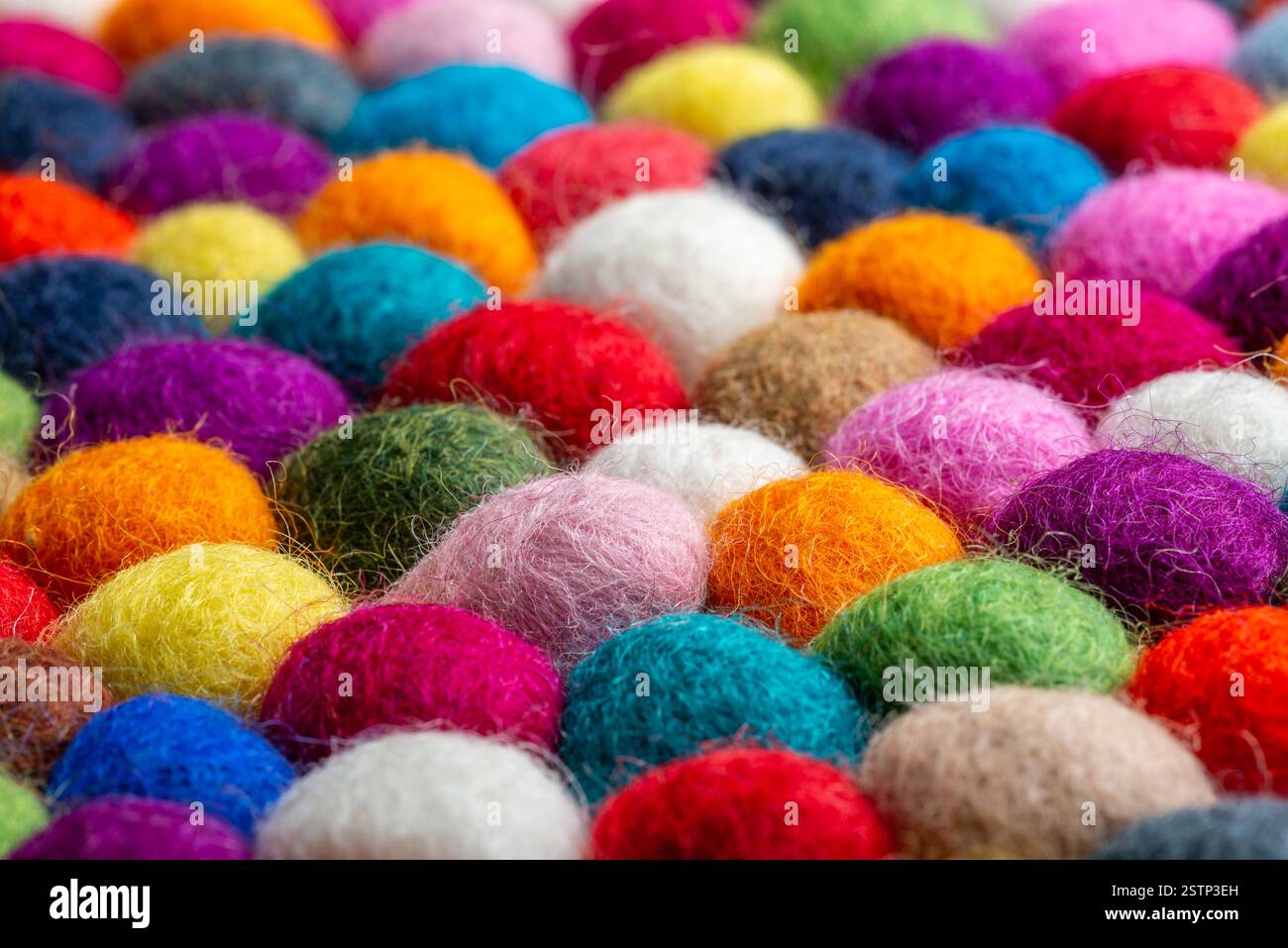 Multicolored felt ball rug detail Stock Photo