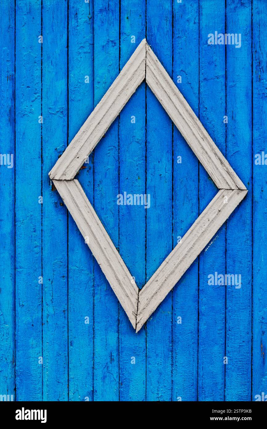 Rural wooden fence painted in blue color with decorative element ...