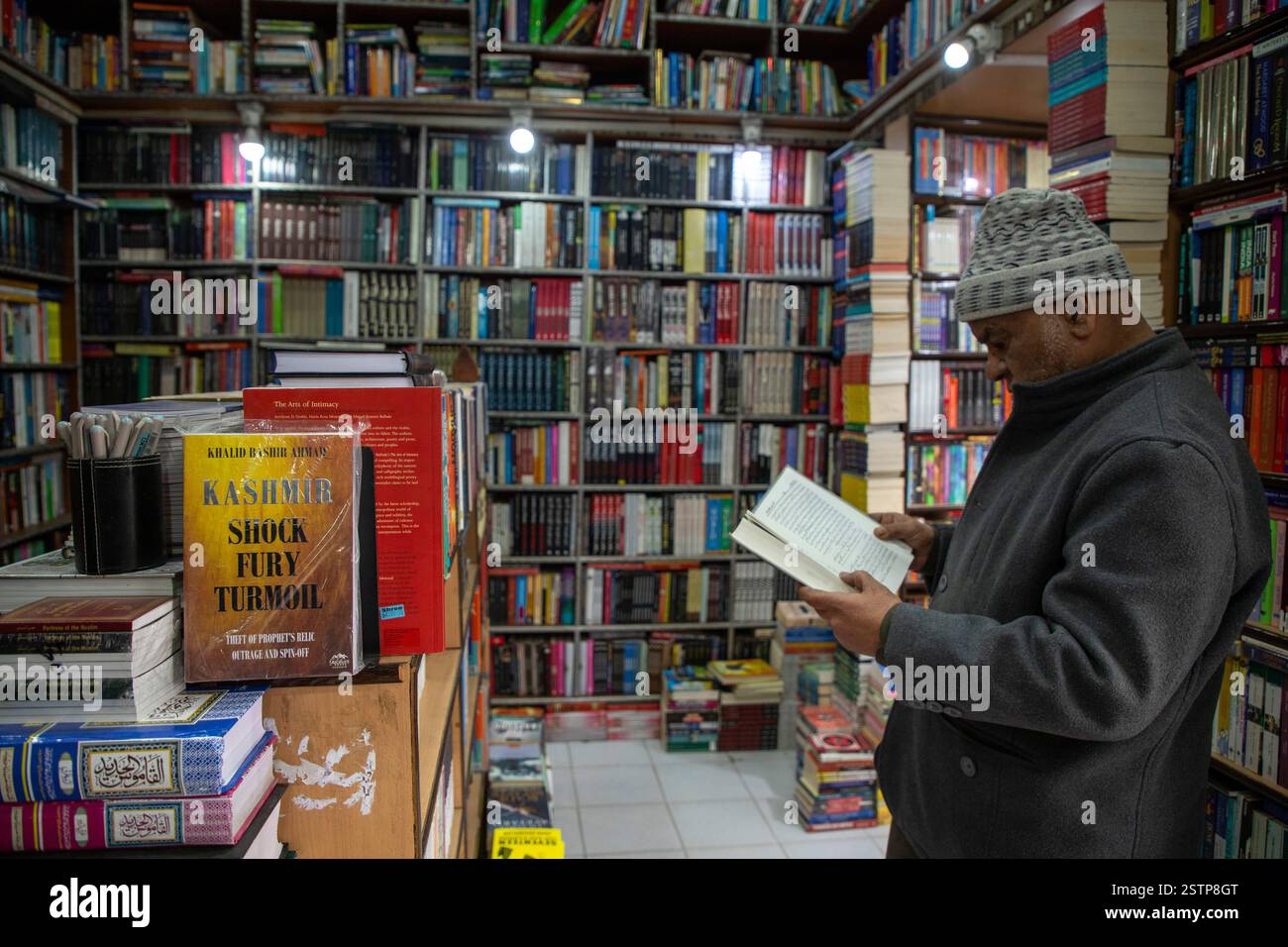 A Kashmiri man reads a book at a bookstore in Srinagar. Police in ...