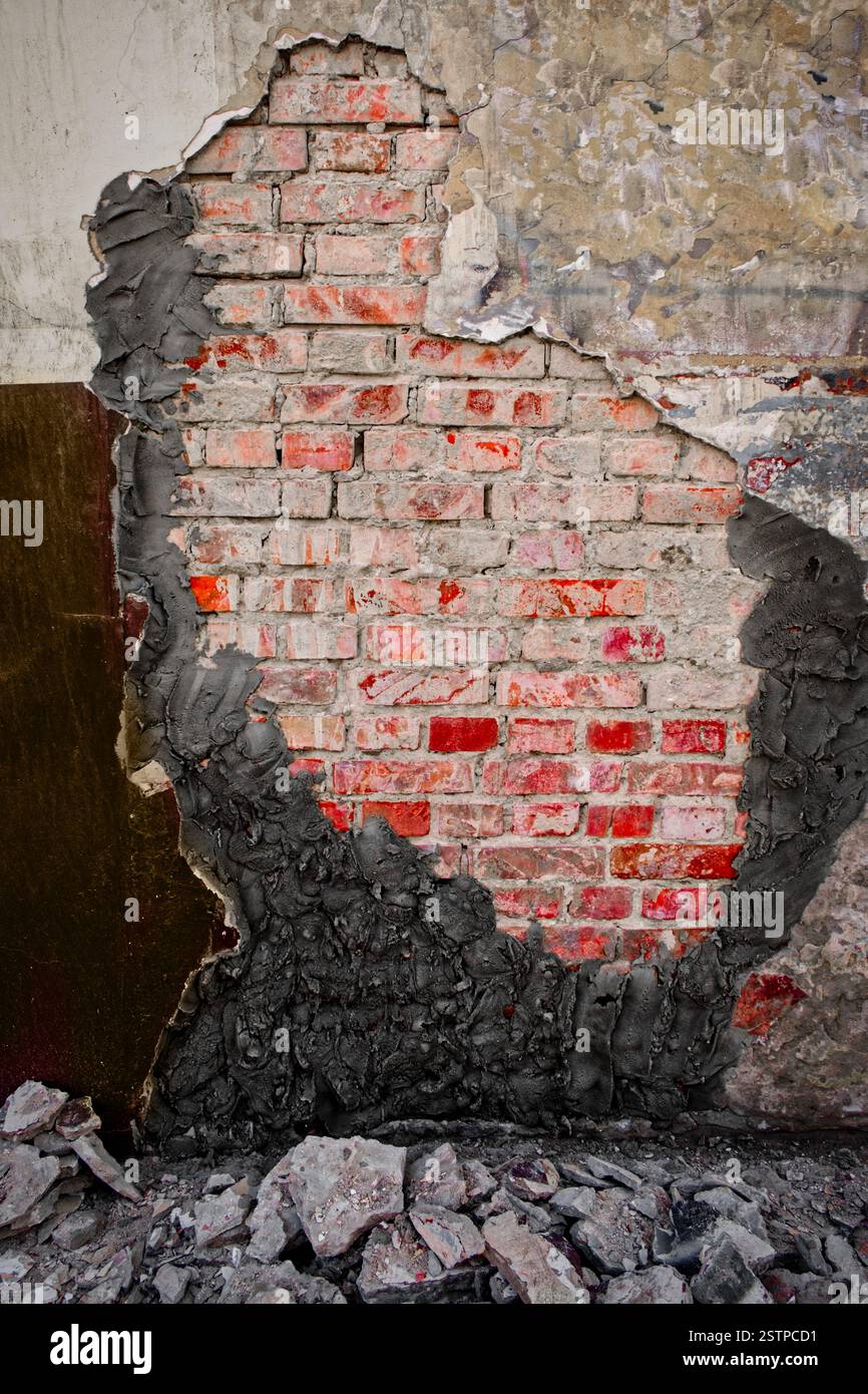 Demolished plaster over worn wall with new cement plaster Stock Photo