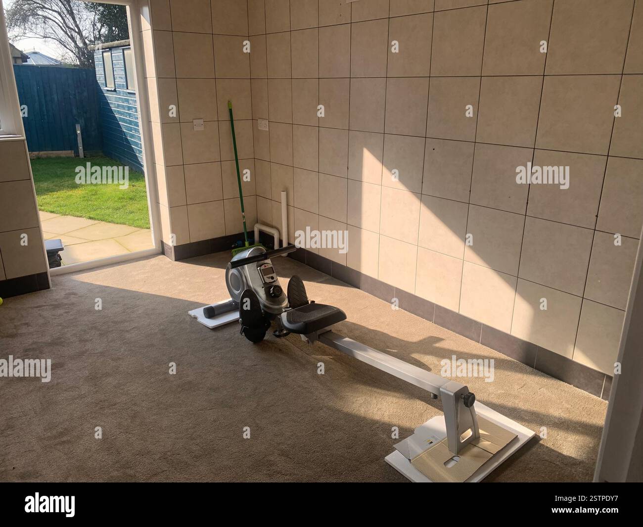 Northampton Towcester Northamptonshire machine room tiles floor exercise  doors shadow shade gymnasium work hard equipment train training trainer - Smartphone Captured Stock Image