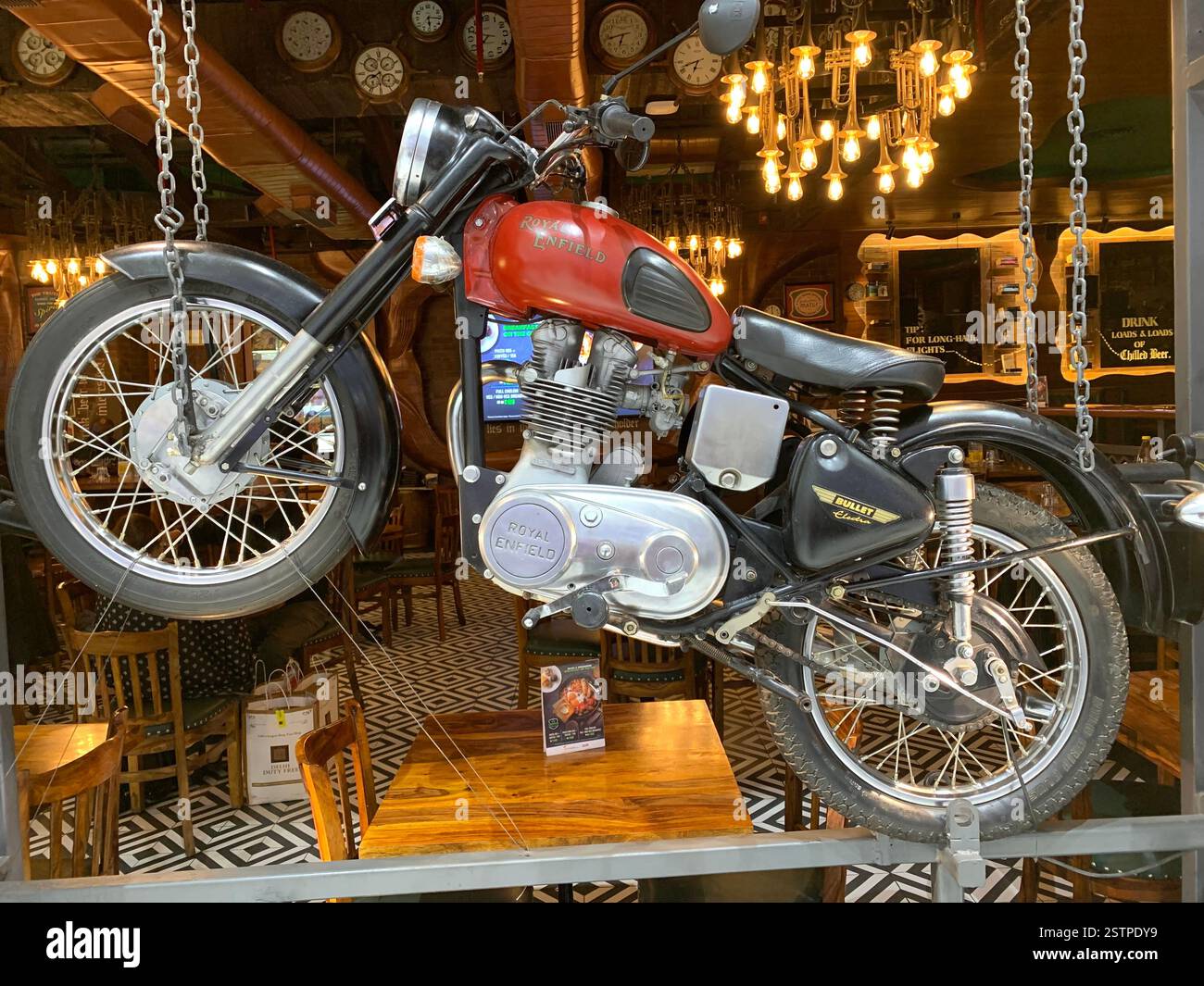 Royal Enfield Motorbike India Delhi parked new old style type wheels engine City parking style British English silver metal fast speed petrol tank - Smartphone Captured Stock Image