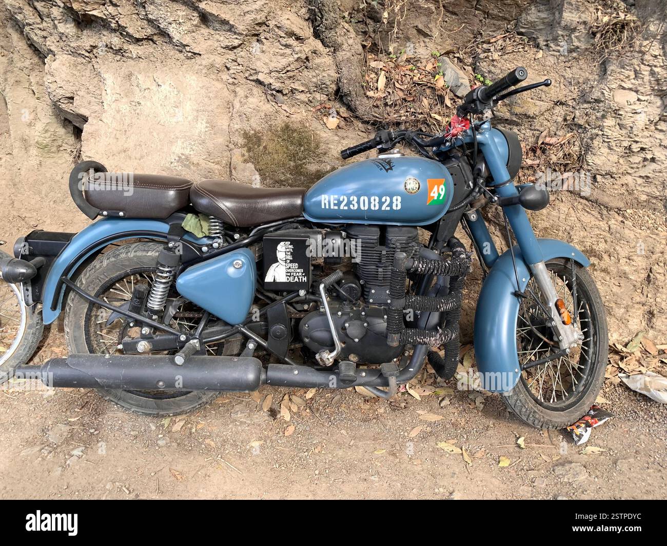 Royal Enfield Motorbike India Delhi parked new old style type wheels engine City parking style British English silver metal fast speed petrol tank - Smartphone Captured Stock Image