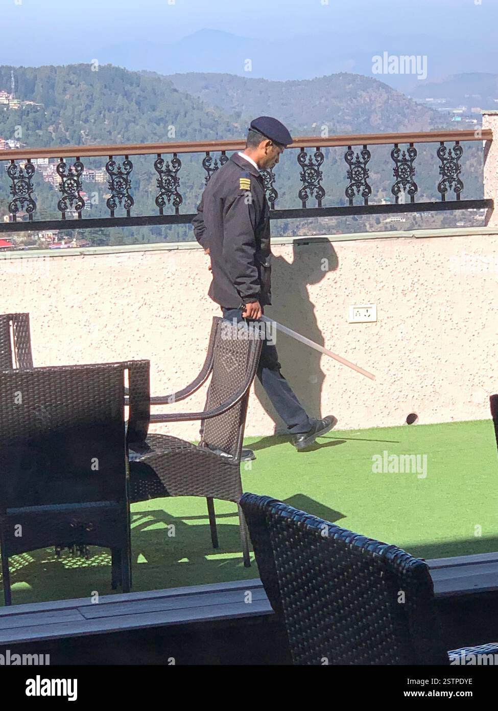 Shimla India guard hotel place mountains Himalaya Himalayan vast large snow weather Summer cap hat stick uniform military berry smart dress - Smartphone Captured Stock Image