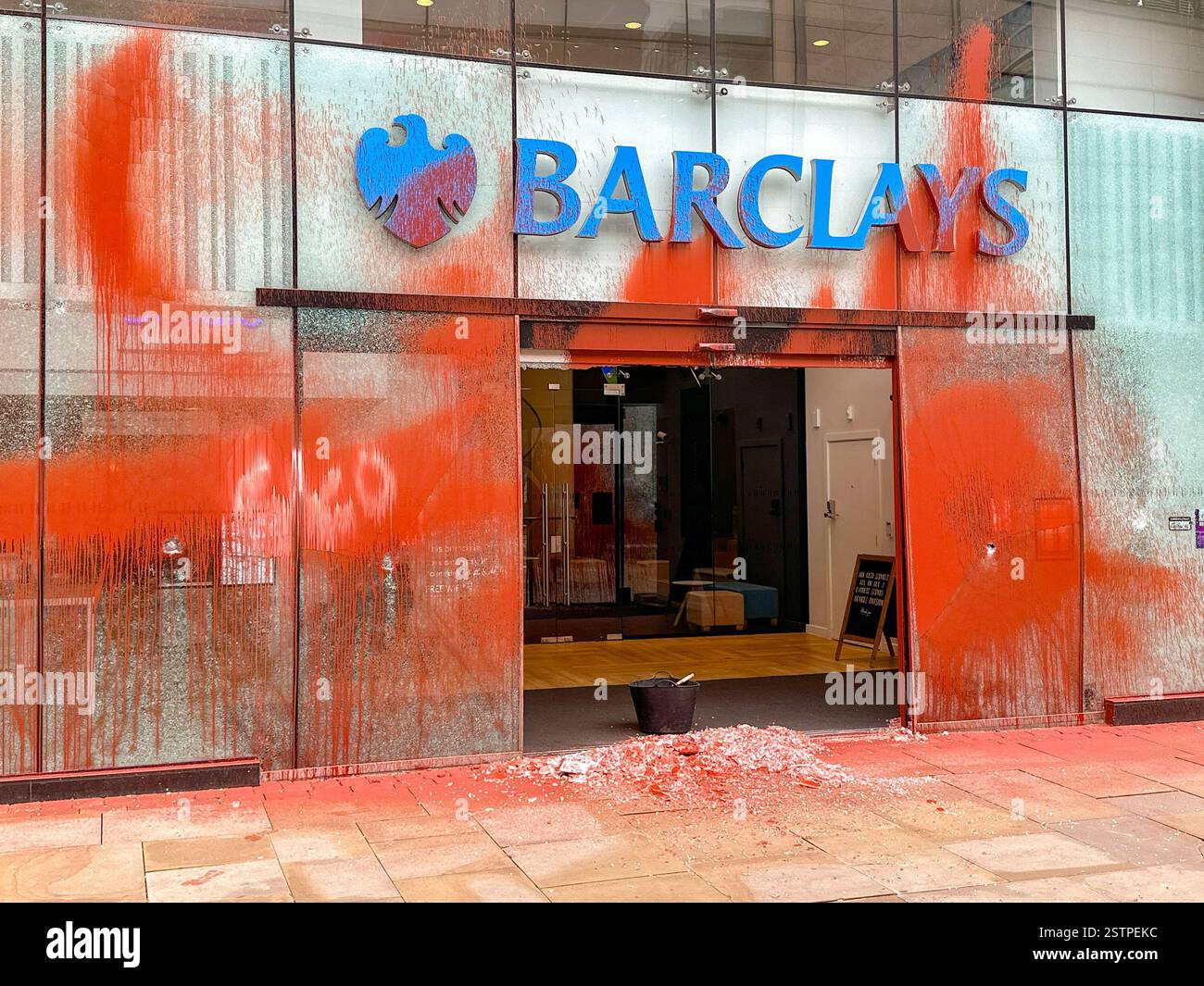 Manchester, England, UK - 31 May 2024: Front view of Barclays Bank in Manchester city centre covered in orange paint thrown by Just Oil protesters - Smartphone Captured Stock Image