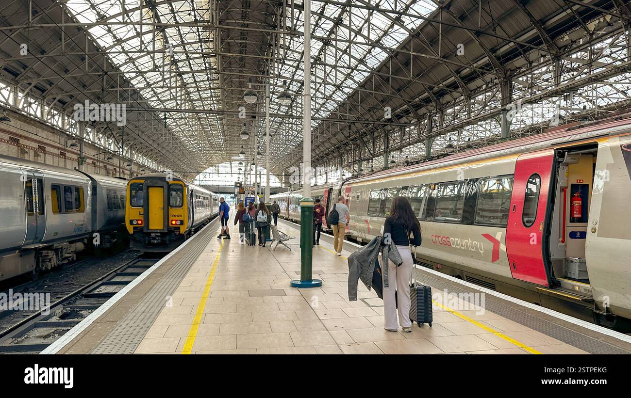 Manchester, England, UK - 31 May 2024: People waiting to catch trains on one of the platforms of Manchester Piccadilly railway station - Smartphone Captured Stock Image
