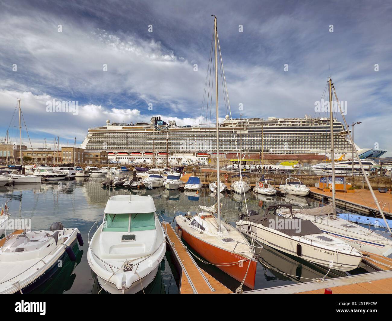 Vigo, Spain - 14 January 2025: Scenic view of the marina in Vigo with a visiting cruise ship, Norwegian Bliss, in the background - Smartphone Captured Stock Image