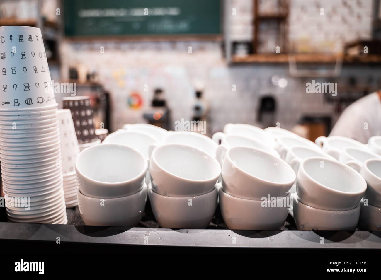 Stack of small ceramic cups on shelf. Stock Photo