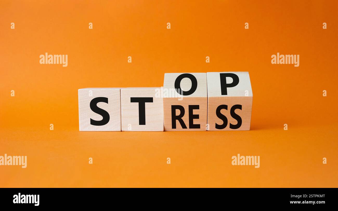 Stop and Stress symbol. Turned wooden cubes with words Stress and Stop ...