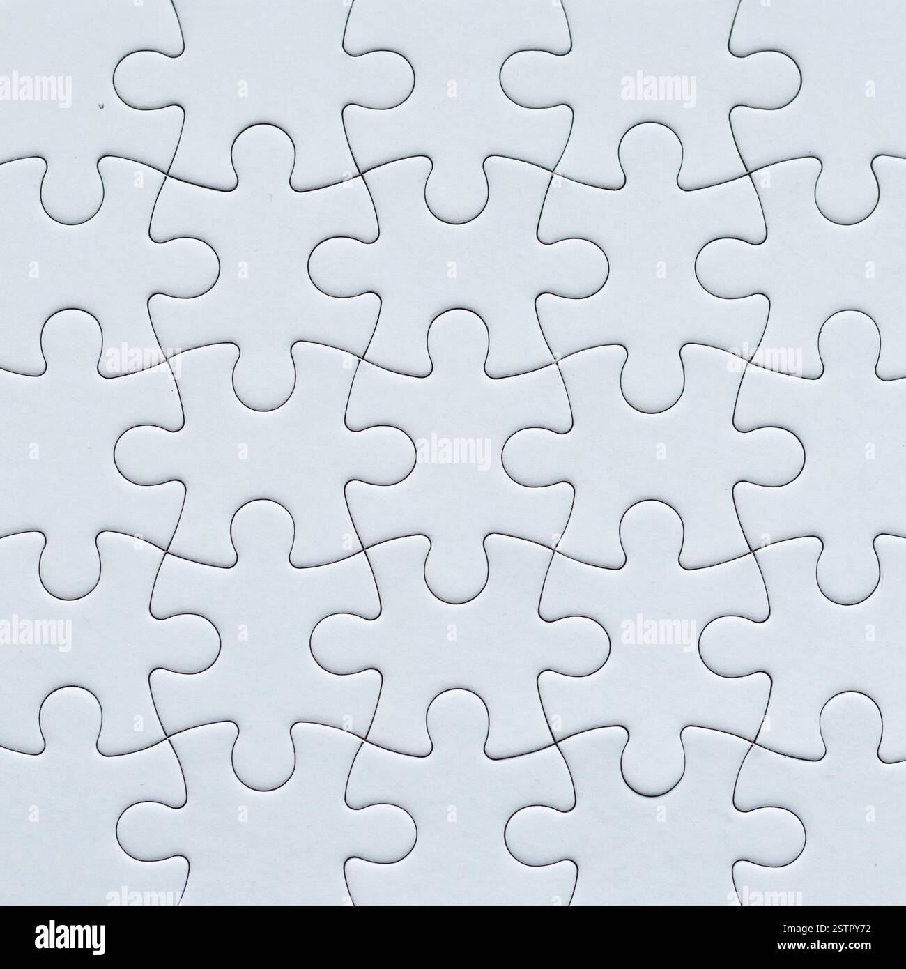 Close-up white jigsaw puzzle background surface with copy space Stock Photo