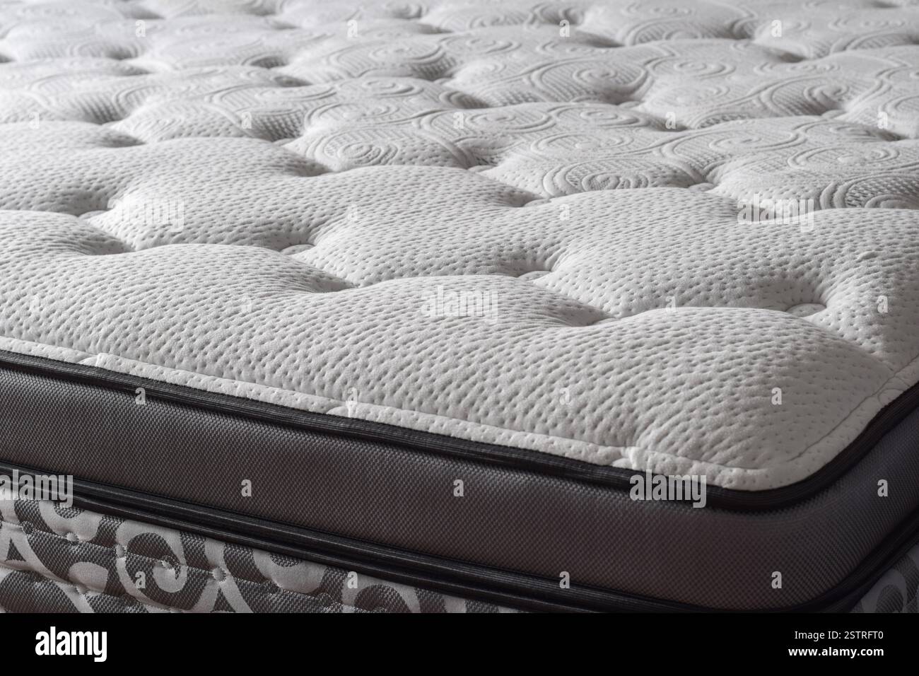 Part of a new white quilted soft mattress Stock Photo