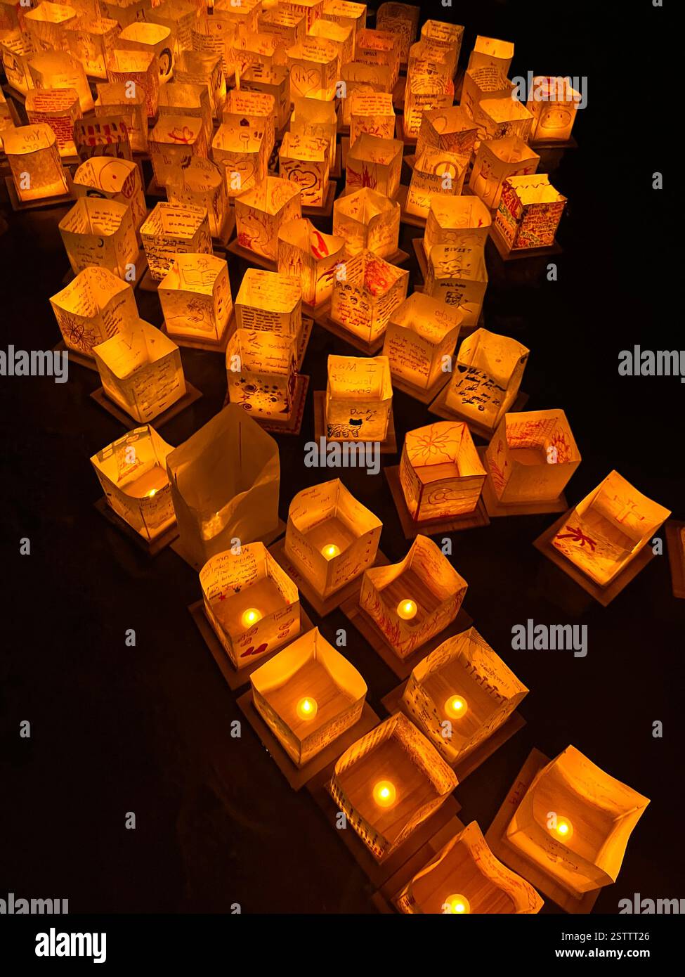hand decorated lanterns float in lake at night time - Smartphone Captured Stock Image
