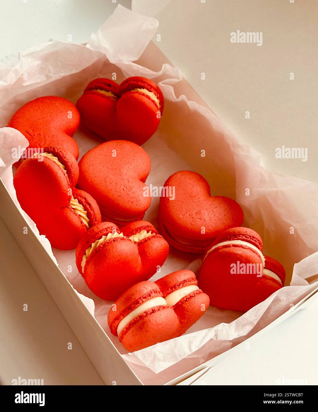 Red macarons in heart shape in the white box - Smartphone Captured Stock Image