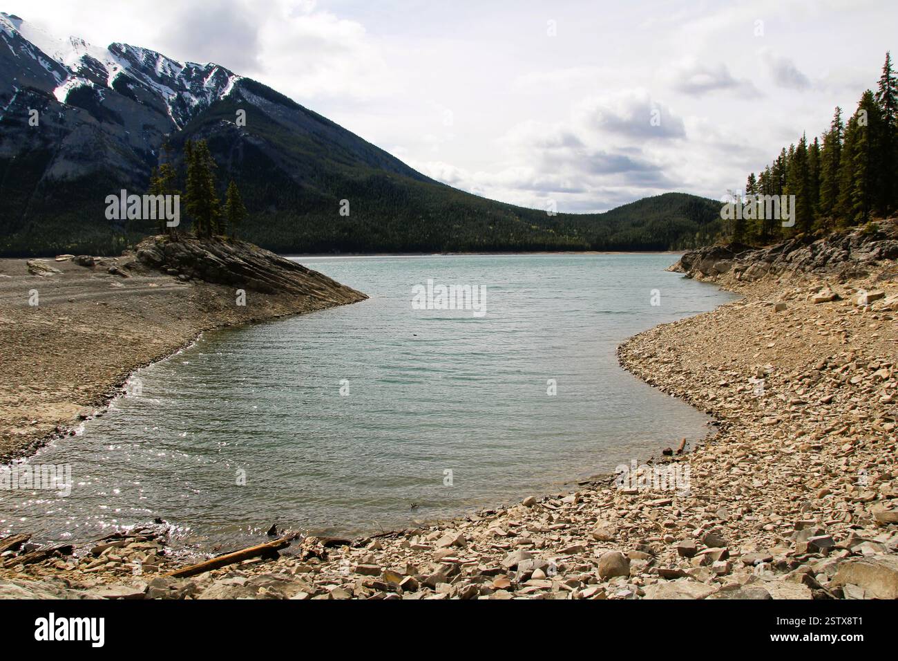 The photo captures a serene landscape featuring a tranquil body of ...