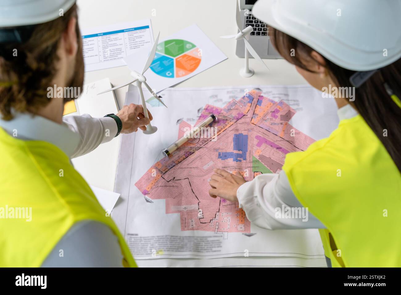 Two engineers looking busy while discussing new project details Stock Photo
