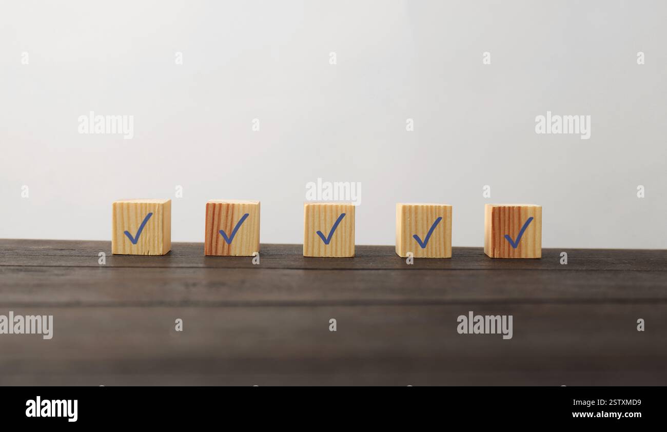 Wooden cubes with check marks on table Stock Photo