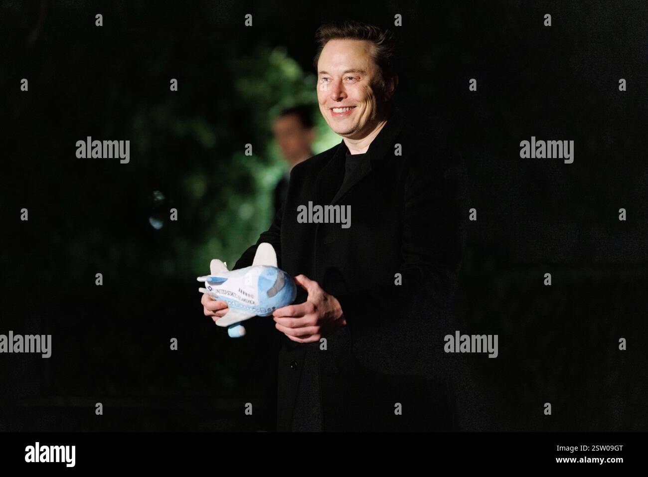Elon Musk is seen with an Air Force One plush toy as he arrives at the ...