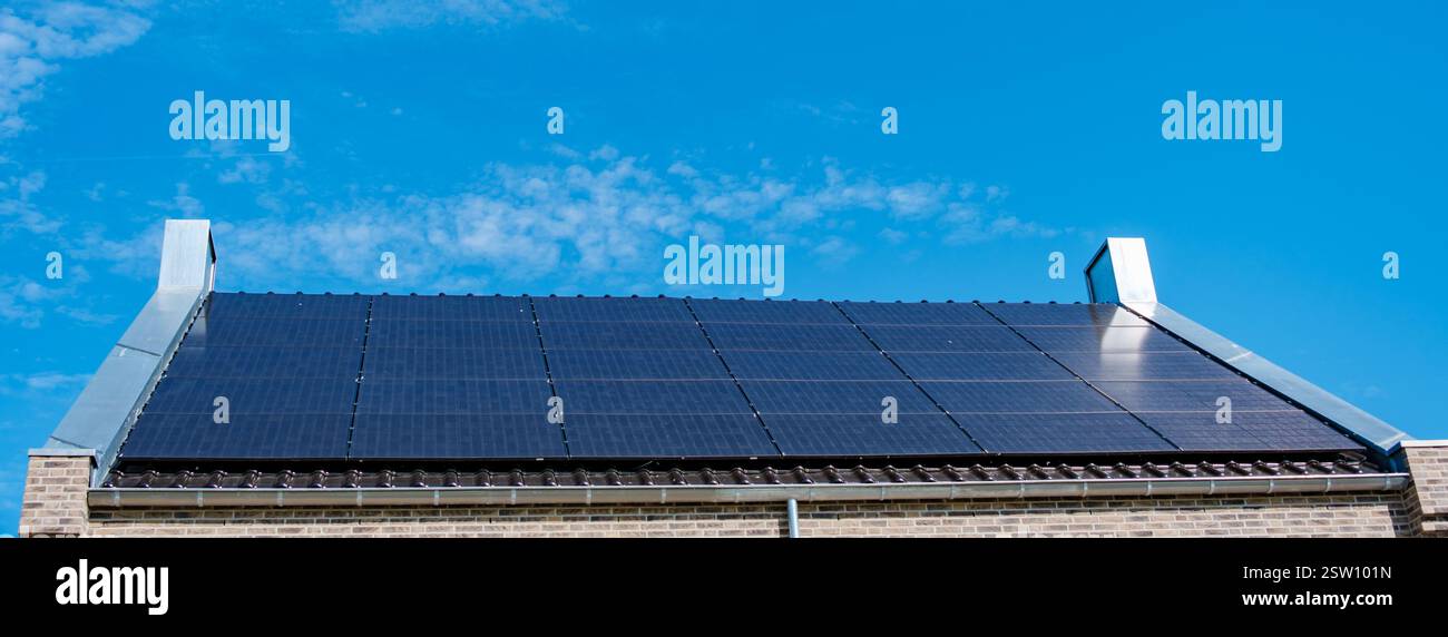 Rows of solar panels harnessing sunlight on a roof hi-res stock ...