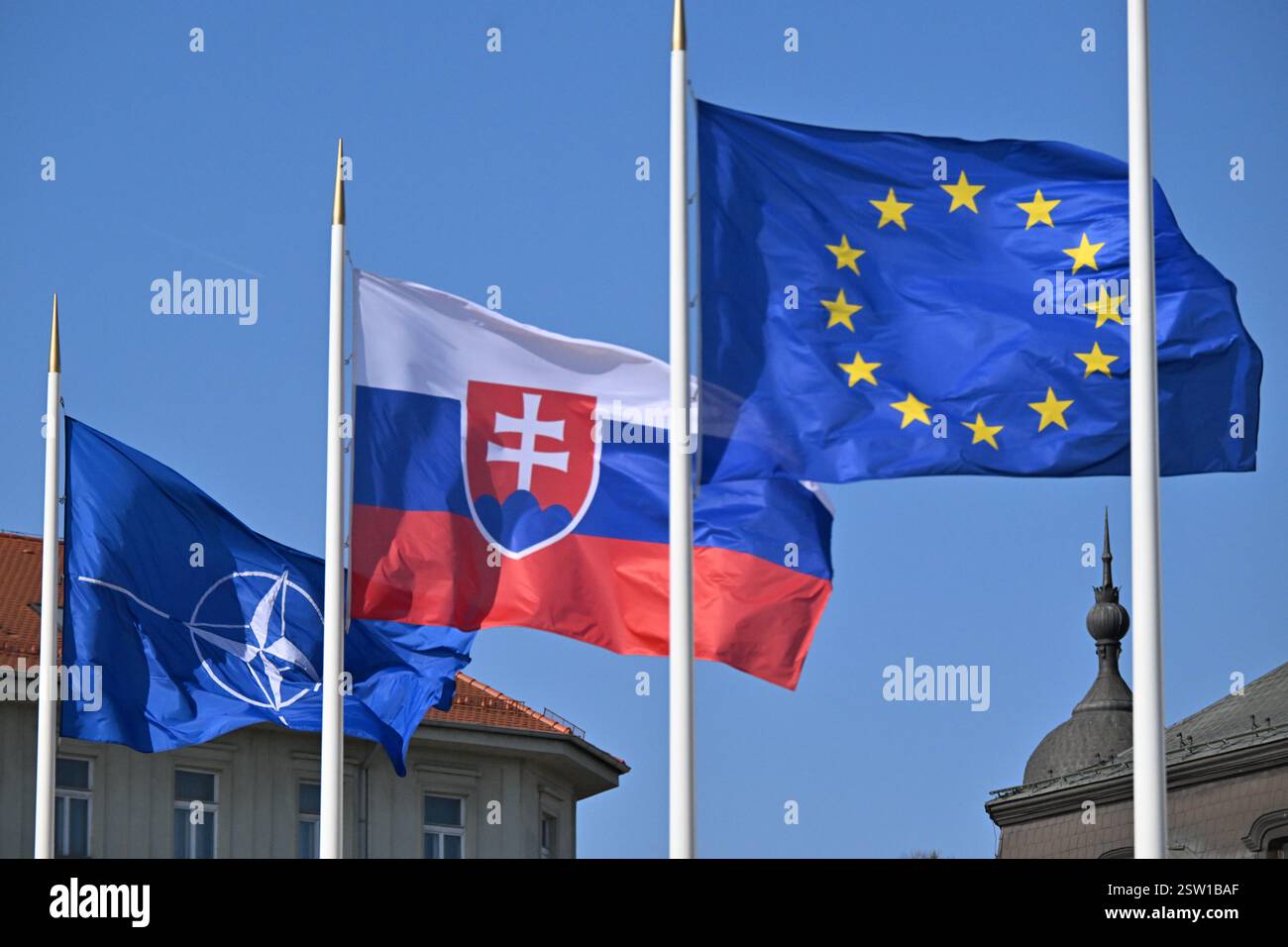 (L-R) Flags of NATO, Slovakia and European Union outside the