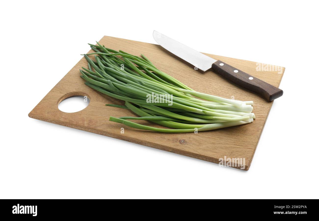Wooden cutting board with green onions and knife isolated on white ...