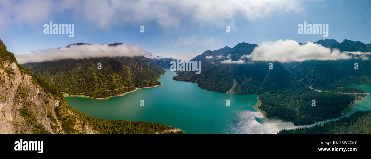 Tranquil panorama of Plansee Lake surrounded by lush mountains in Austria Stock Photo