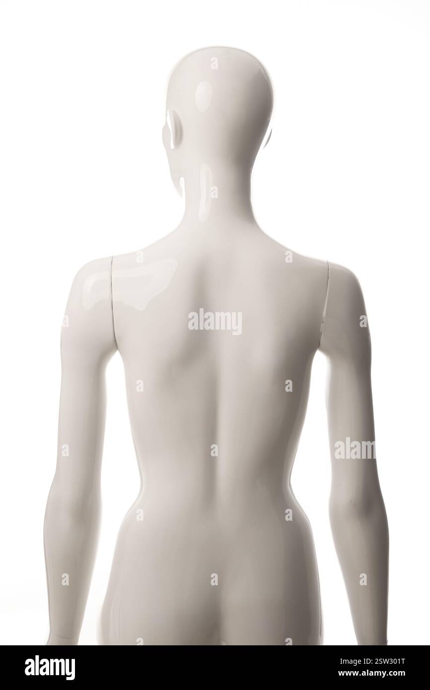 Half-length shot of a white fibreglass female mannequin facing away from the camera, seen against a white background Stock Photo