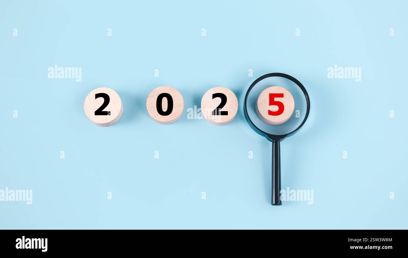 Trends Economy Of Magnifying Glass With 2025 On Light Blue Background Business Trends 2025 Trends Economy Of Magnifying Glass With 2025 On Light Blue Background Business Trends 2025 Concept Focus Of Trends For Business Fashion And Technolo 2SW3W8M 
