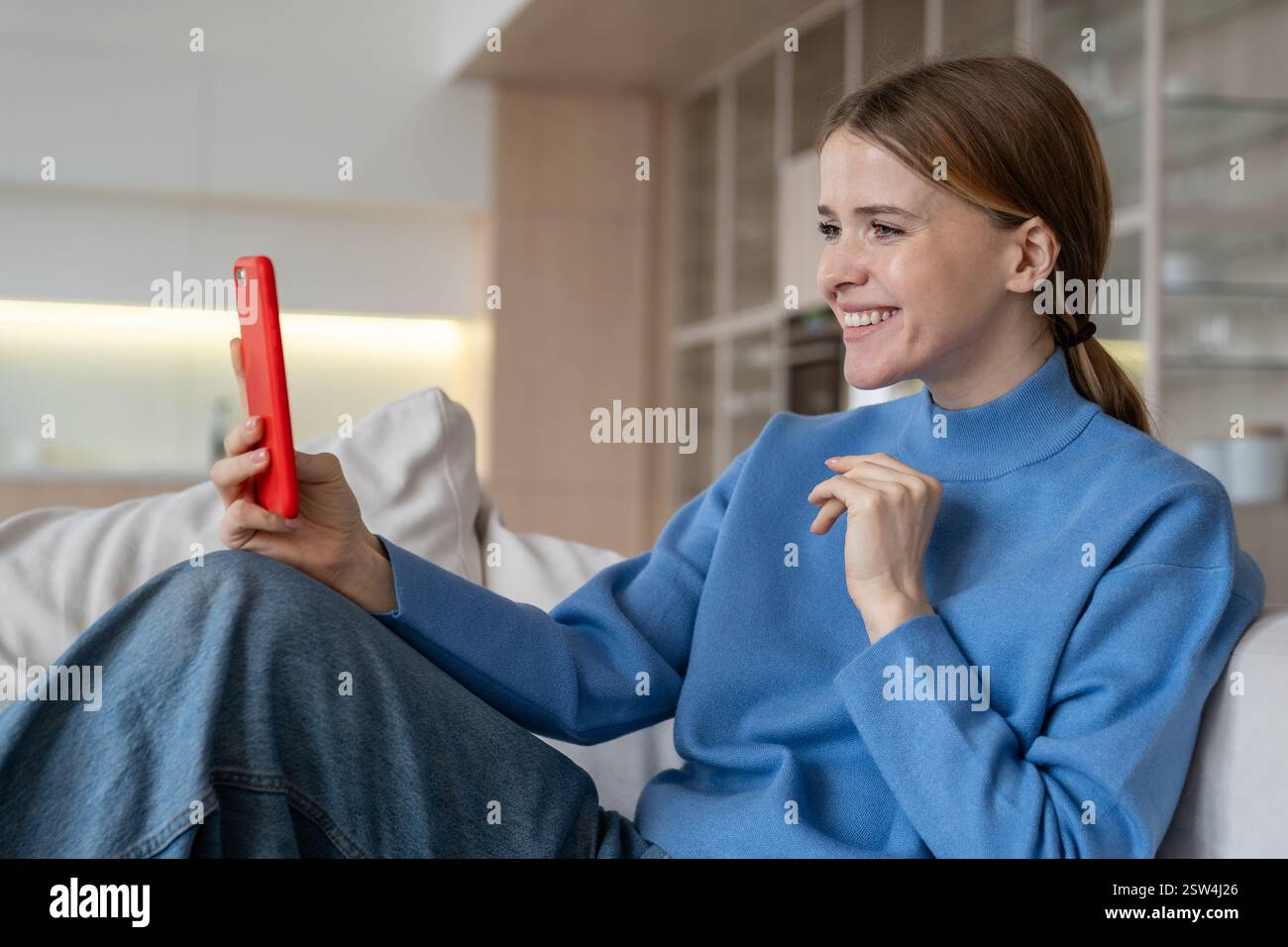 Relaxed happy woman take selfie, video call by phone on sofa at home. Online date, job interview Stock Photo