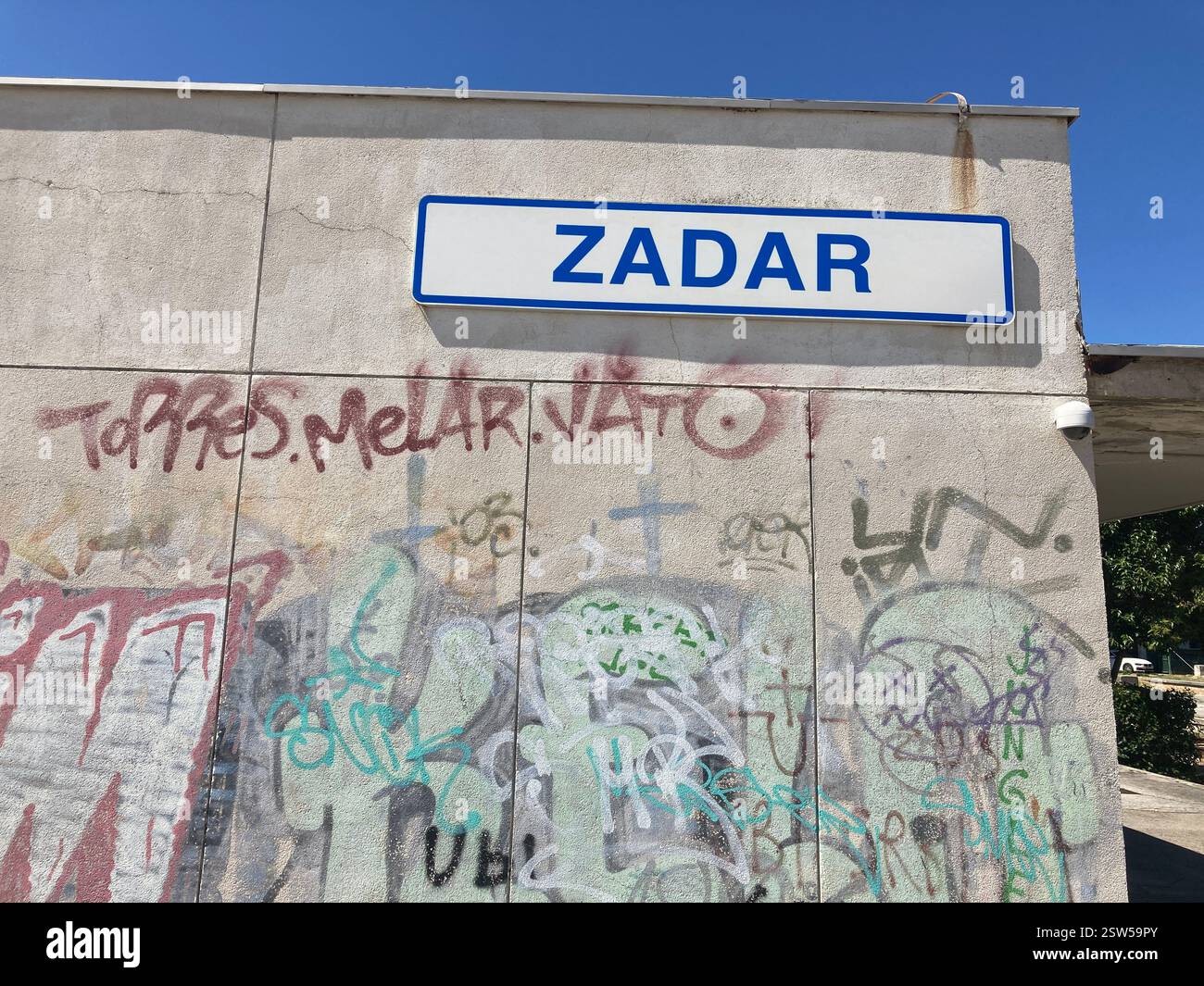 Abandoned railway station in Zadar, Croatia. Concrete building and railroad tracks with graffiti abandoned desolate ruin public transport by rail - Smartphone Captured Stock Image