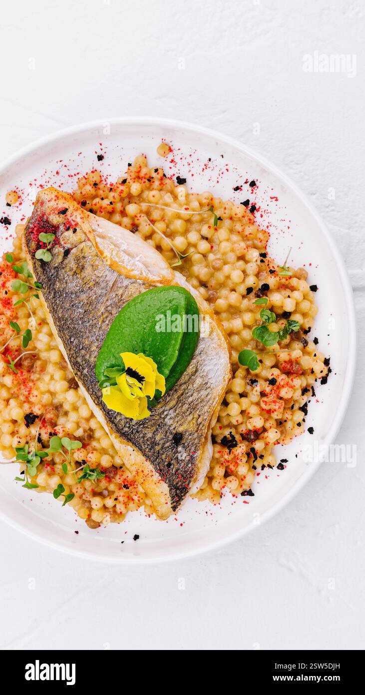 Grilled salmon fillet with herb couscous on plate Stock Photo - Alamy