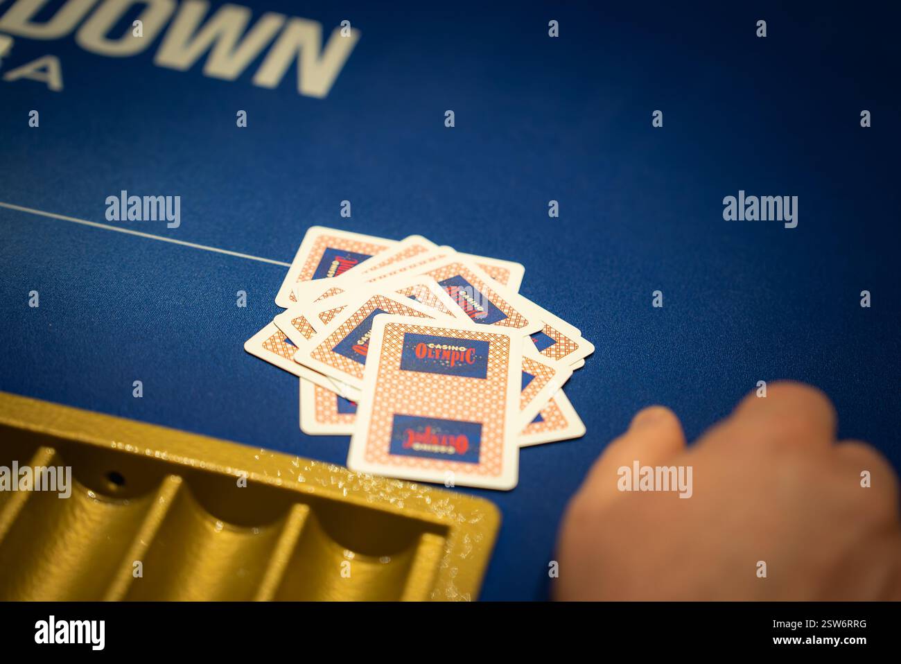Close Up of Poker Game on Blue Felt Table with Cards and Chip Tray Stock Photo