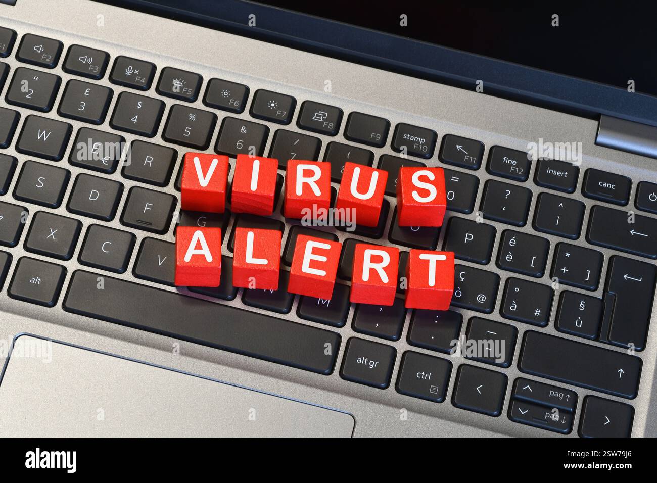 text 'VIRUS ALERT' on a laptop keyboard. Cyber ​​security concept Stock Photo