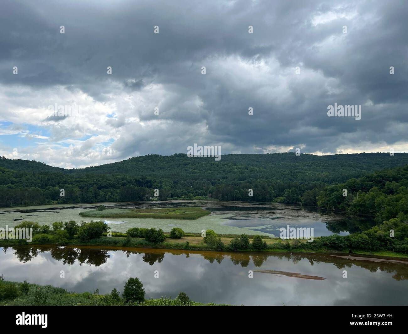 A view of the surrounding area from the top of the Vermont Institute of Natural Science tower. A sky full of moody clouds and calm waters. - Smartphone Captured Stock Image