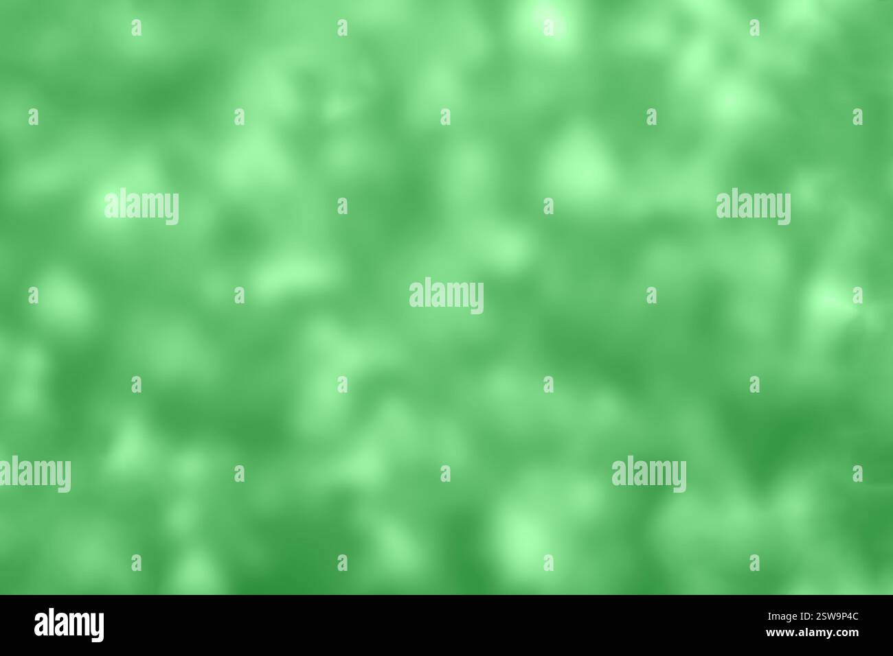 Green blurred abstract background with bokeh effect creating a calming appearance Stock Photo