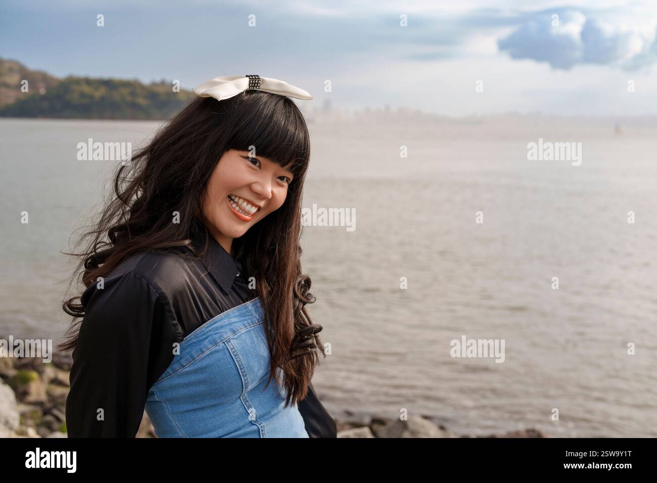 Young Woman Wearing Bow San Francisco Bay Cloudy Day Stock Photo