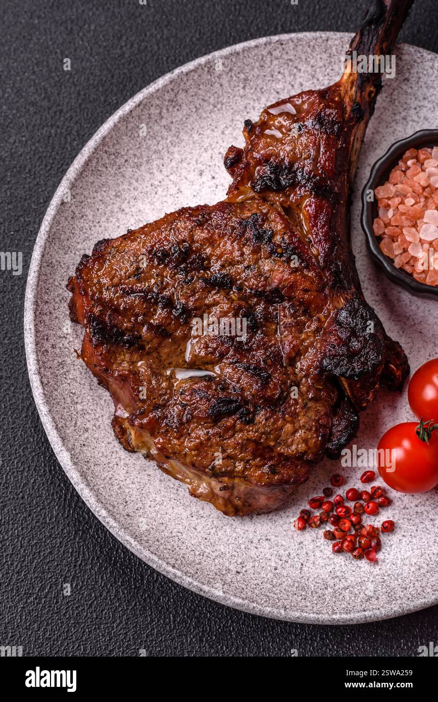 View of Grilled wagyu beef tomahawk steak with salt, spices and herbs Stock ...