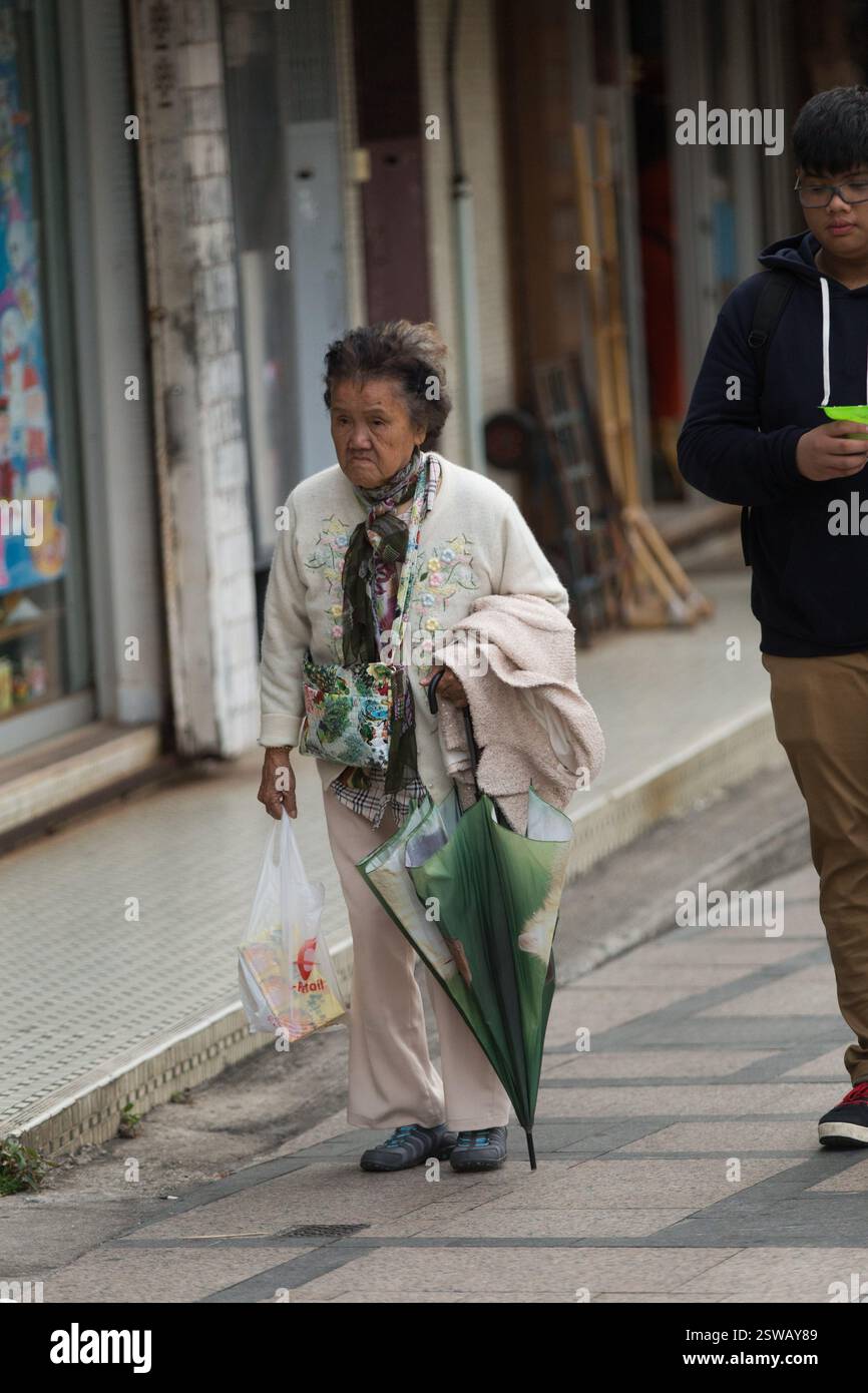 Elderly woman umbrella walks hi-res stock photography and images - Alamy