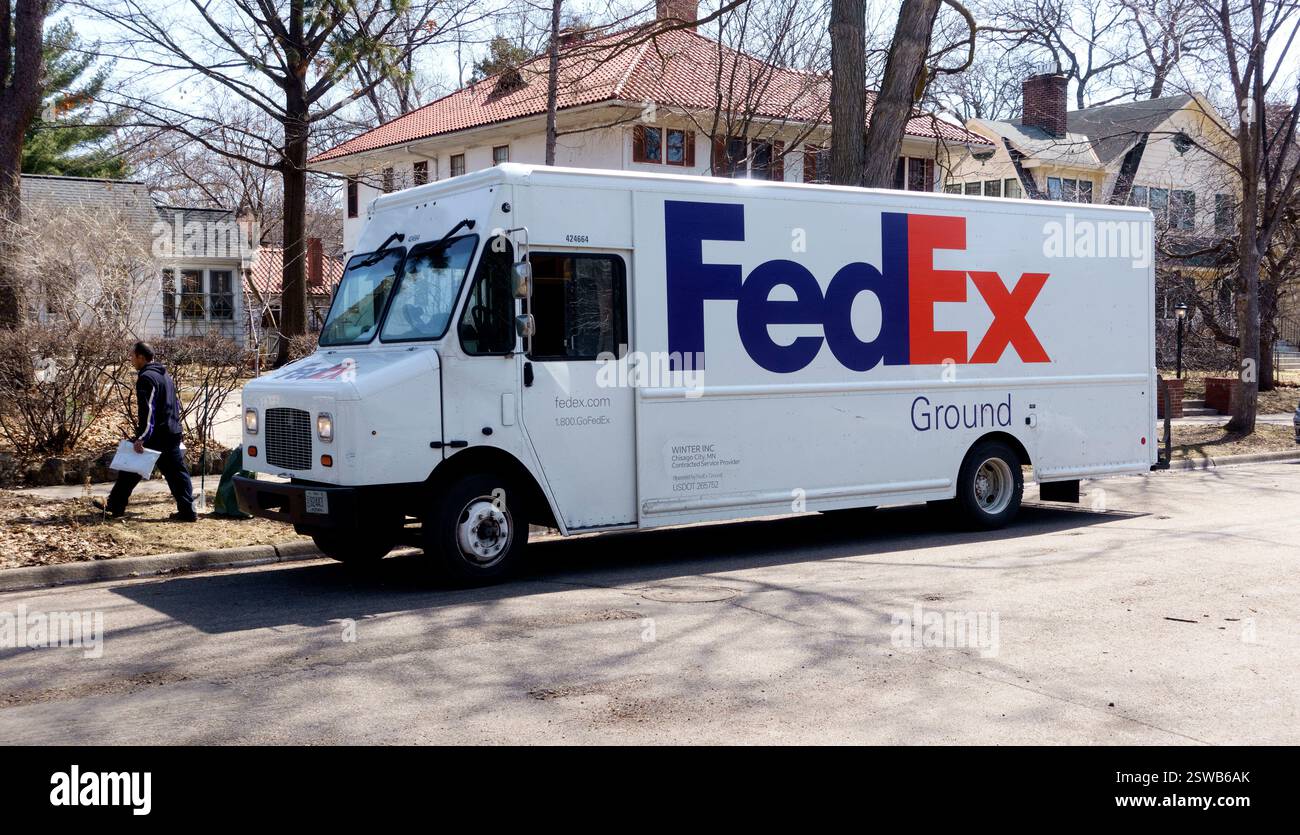 FedEx truck making a delivery in a residential neighborhood. St Paul Minnesota MN USA Stock Photo