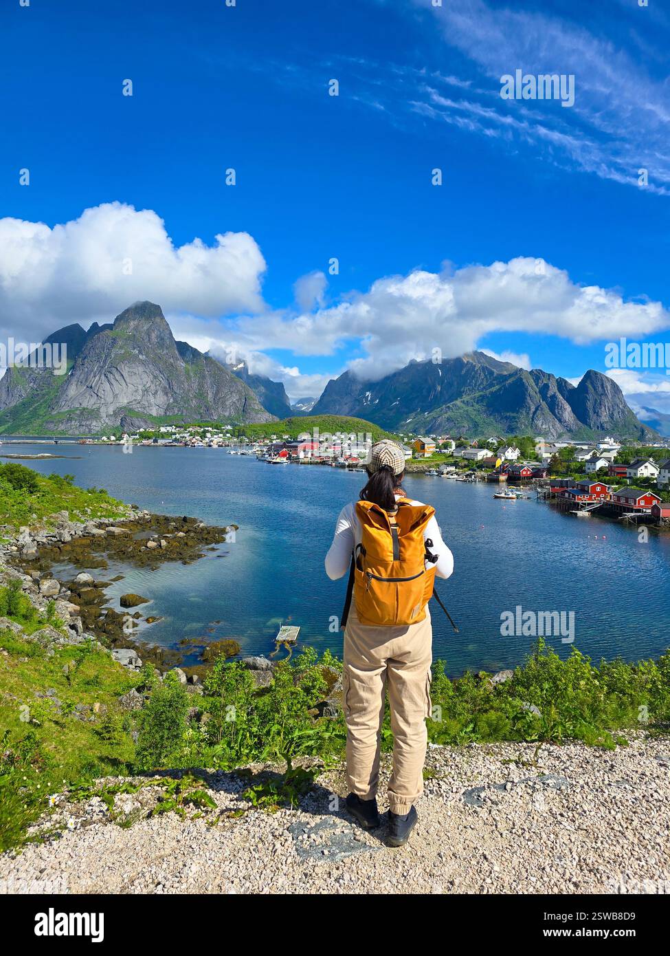 Stunning view of mountains and a vibrant village from a sunny hiking spot at the Lofoten Norway Stock Photo