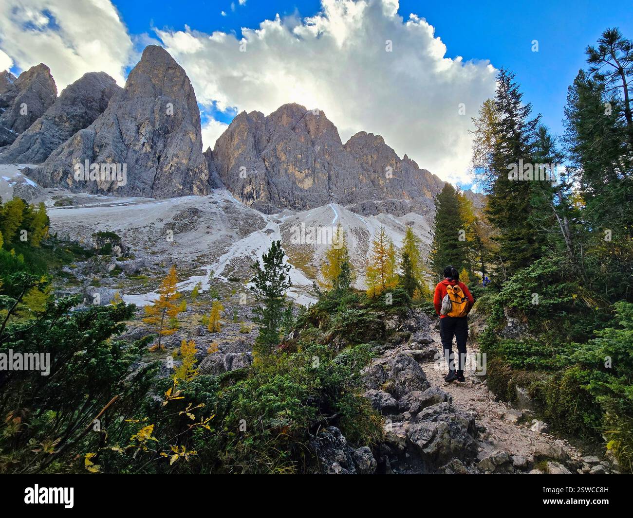 The Stunning Dolomites Women With A Backpack Hiking In The Mountains the-stunning-dolomites-women-with-a-backpack-hiking-in-the-mountains